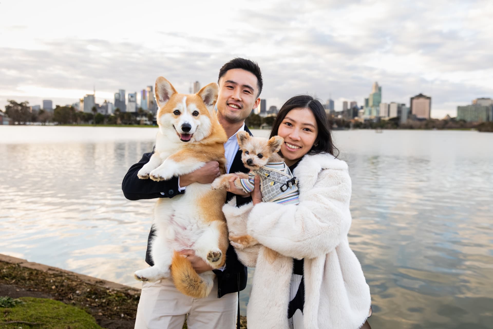 Michael and Karly holding their dogs beside the lake